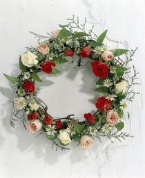 Wreath of pink, red and white roses and green vines on white wall by Panoramic Images