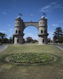 Flags on the top of a gateway arch, Cordoba, Argentina by Panoramic Images