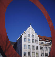Low angle view of a building through a red circular sculpture von Panoramic Images
