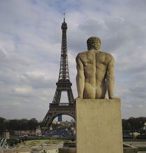 Statue of a naked man in front of a tower, Eiffel Tower, Paris, France by Panoramic Images