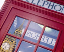 Reflection of a clock tower on the glass of a telephone booth von Panoramic Images