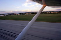 Wing of a private plane landing at the airport