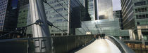 Bridge in front of buildings, Canary Wharf, London, England by Panoramic Images