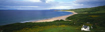 Birds-eye view of sea, white stone cottage, Northern Ireland. by Panoramic Images