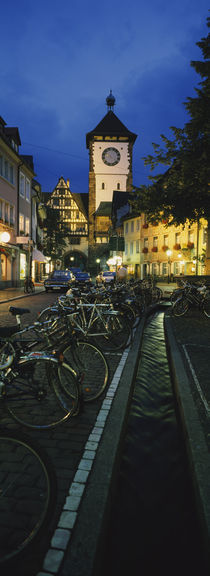 Bicycles parked along a stream near a road, Freiburg, Baden-Württemberg, Germany von Panoramic Images