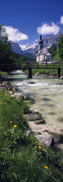 Bridge over stream below country church, Bavarian Alps, Germany. von Panoramic Images