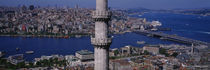 minaret with bridge across the bosphorus in the background, Istanbul, Turkey by Panoramic Images