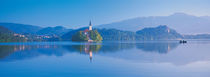 Reflection of mountains and buildings in water, Lake Bled, Slovenia by Panoramic Images