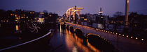 Bridge lit up at night, Magere Brug, Amsterdam, Netherlands by Panoramic Images