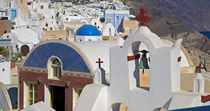 Greece and Greek Island of Santorini town of Oia with Blue Domed Churches with white and colorful buidling surrounding them with the bell tower in the foreground by Danita Delimont