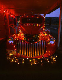 Vintage fire truck decorated with lights at Christmas by Danita Delimont