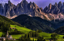 Beautiful isolated lonely church St Maddalena and village in valley in the Italian Dolomites village of Val Di Funes mountains Alpine area of Italy with Dolomites looming behind by Danita Delimont