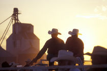 Two men shake hands at a rodeo by Danita Delimont