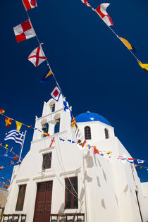 Greece and Greek Island of Santorini town of Oia Blue Domed Church with flags flying by Danita Delimont