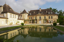 The main chateau building with its tower and a pond showing a reflection Chateau Bouscaut Cru Classe Cadaujac Graves Pessac Leognan Bordeaux Gironde Aquitaine France by Danita Delimont
