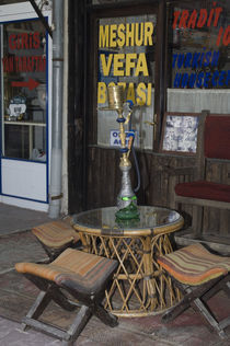 Cappadocia; sidewalk cafe table with Turkish water pipe and folding stools von Danita Delimont