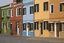 Colorful row of homes and empty street by Danita Delimont