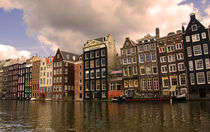 View of the unique architecture and gabled homes and coffee shop along a colorful canal von Danita Delimont