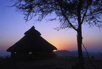 Sunset over a traditional Konso hut by Danita Delimont