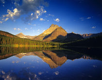 Mount Wilbur reflects into calm Fishercap Lake in Glacier National Park in Montana by Danita Delimont