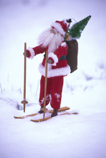 Toy Santa Claus on skis and snow by Danita Delimont