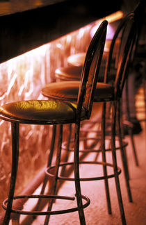 Barstools in pink light by Danita Delimont