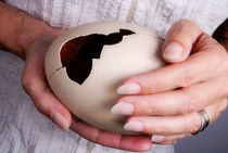 Woman holding broken ostrich egg by Sami Sarkis Photography