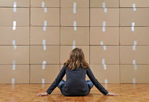 Girl seated in front of cardboard boxes von Sami Sarkis Photography