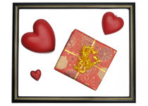 Gift box and heart-shaped objects in picture frame von Sami Sarkis Photography