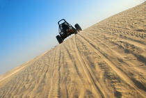 Beach buggy speeding across desert by Sami Sarkis Photography