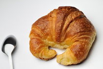 French croissant with spoon on white background von Sami Sarkis Photography