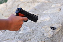 Woman pointing a toy gun on butterfly von Sami Sarkis Photography