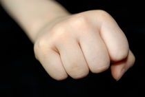 Little girl making fist by Sami Sarkis Photography