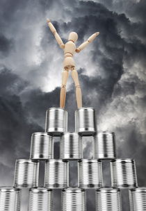 Winner mannequin on top of tin cans pyramid by Sami Sarkis Photography