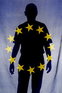 Silhouette of man behind European Union Flag by Sami Sarkis Photography