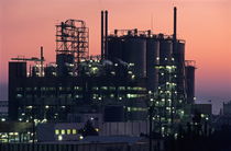 Illuminated petroleum refinery at sunset by Sami Sarkis Photography
