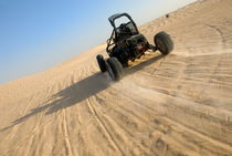Beach buggy speeding across Sahara desert  by Sami Sarkis Photography