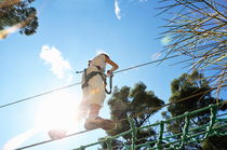 Girl walking on suspended footbridge by Sami Sarkis Photography