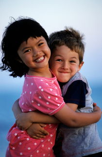 Girl and boy (7-9) embracing by Sami Sarkis Photography