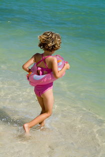 Girl running into water on beach von Sami Sarkis Photography