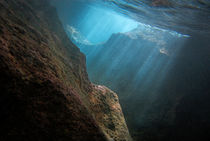 Sunrays penetrating underwater cave near surface by Sami Sarkis Photography