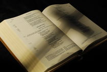 Crucifix shadow on French Holy Bible by Sami Sarkis Photography