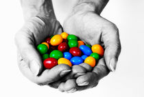 Woman holding coloured chocolate eggs by Sami Sarkis Photography