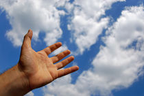 Mans hand reaching for clouds by Sami Sarkis Photography