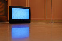 Television displaying static reflected in floor von Sami Sarkis Photography