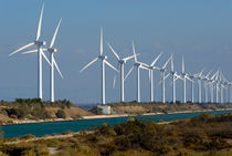 Row of wind turbines along canal by Sami Sarkis Photography