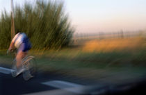 Cyclist on road von Sami Sarkis Photography