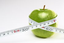 Tape measure round green apple by Sami Sarkis Photography