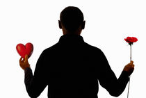 Silhouette of man holding heart and rose by Sami Sarkis Photography