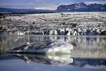 Floating icebergs reflected in the quiet waters of Jokulsarlon by Sami Sarkis Photography